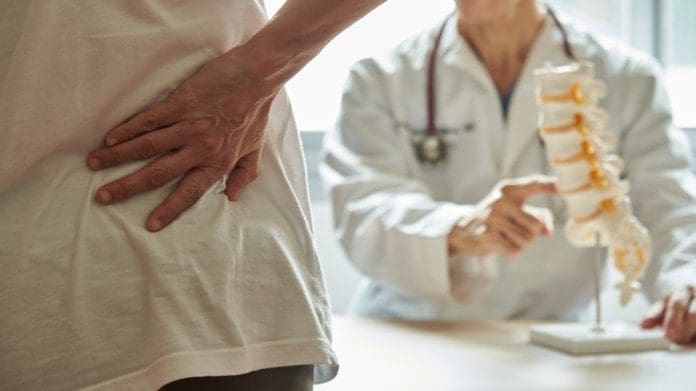 A doctor explaining lumbar anatomy to back pain patient