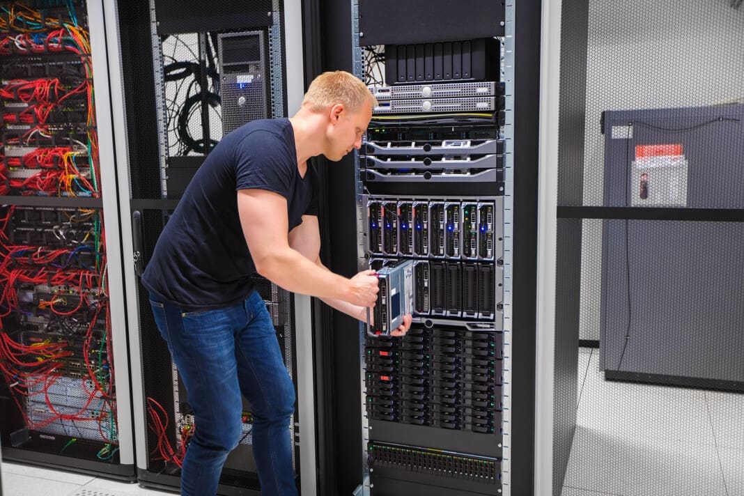 Computer Engineer Installing Server Into Blade Enclosure Leg Pain After Long Hours of Server-Floor Work in Data Centers