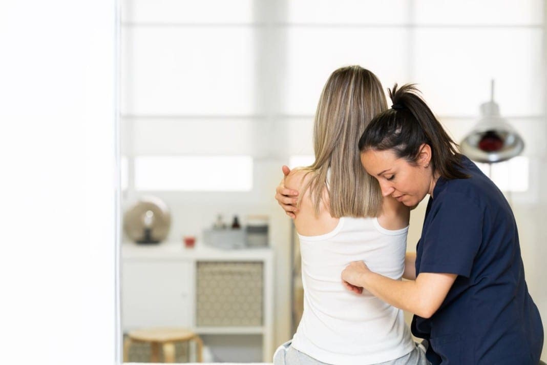 Physiotherapist inspecting her patient in a physiotherapy center. 11860 Vista Del Sol, Ste. 128 Chronic Pain Treatment/Management