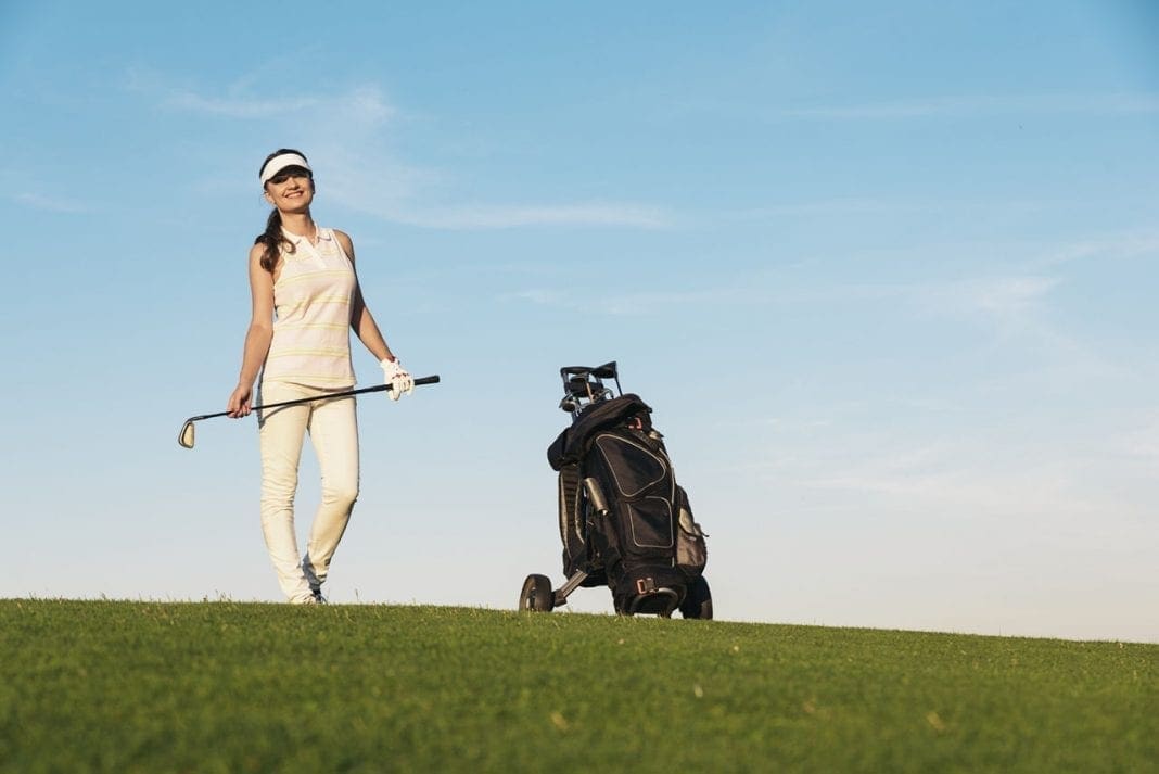 Pretty young woman playing golf. 11860 Vista Del Sol, Ste. 128 Golf Injuries and Prevention