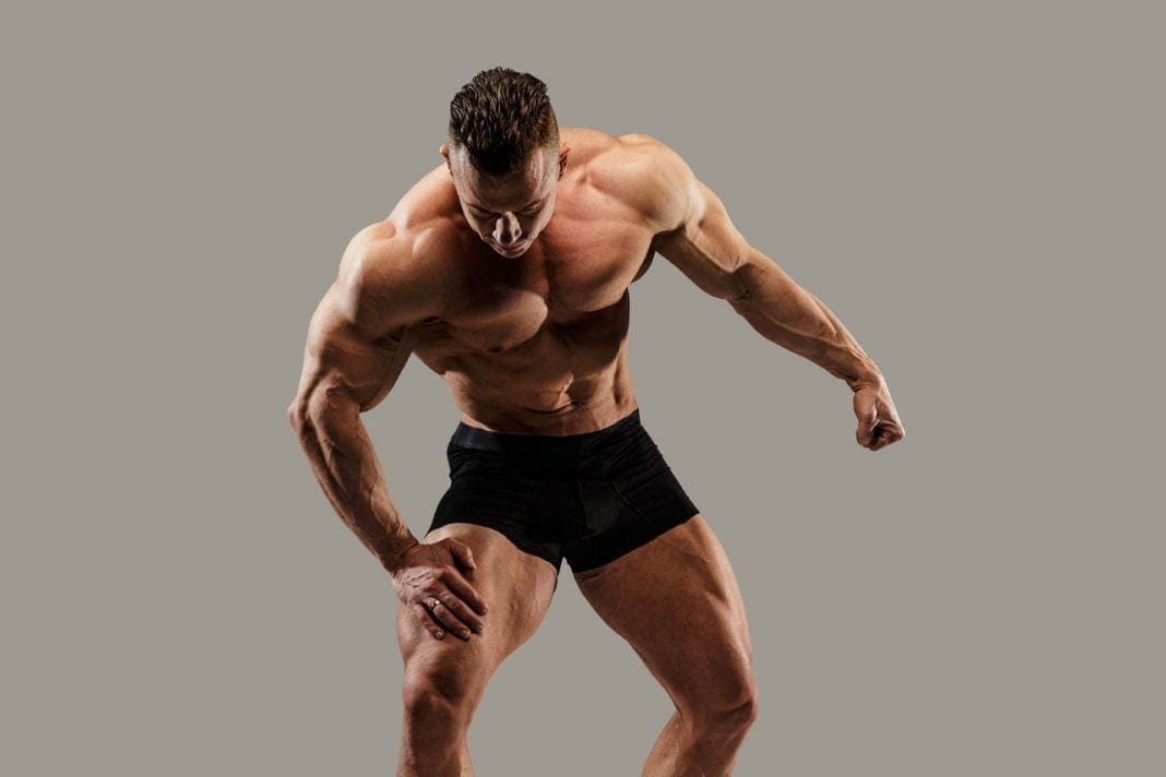 Bodybuilder posing in studio 11860 Vista Del Sol, Ste. 128 Weightlifting Fitness and Chiropractic The Perfect Team