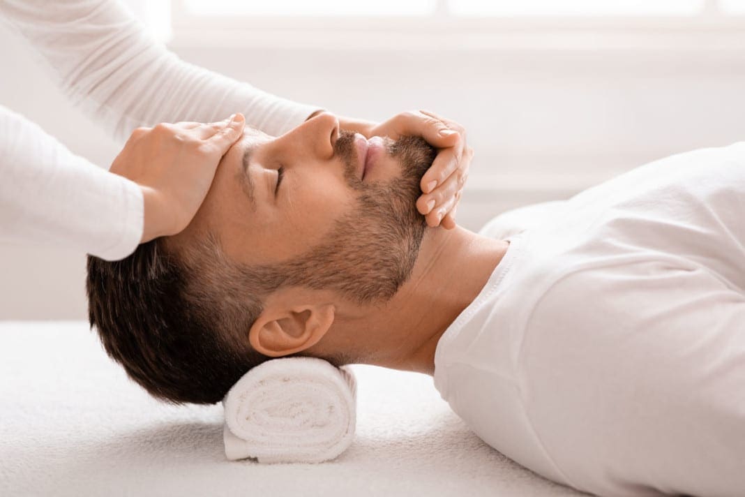 Sleeping man getting healing face massage at spa 11860 Vista Del Sol, Ste. 128 Combat Insomnia with Chiropractic Care