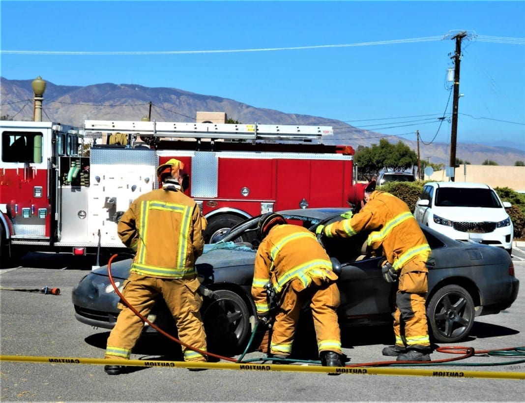 people-from-behind-firefighters-work-as-a-team-to--5U98P9X_02 11860 Vista Del Sol, Ste. 128 Whiplash and Chronic Whiplash Injuries Following An Automobile Accident