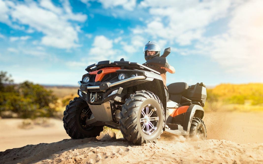 Summer offroad adventure on atv in sand quarry