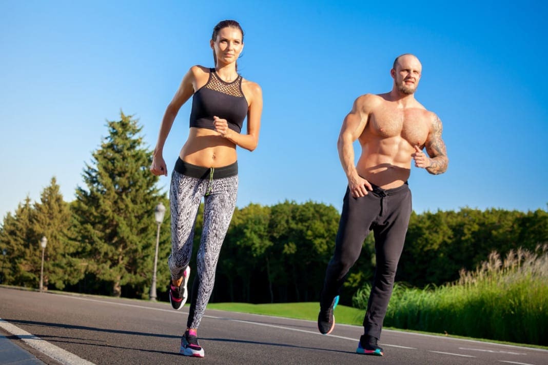 Man and woman running in park