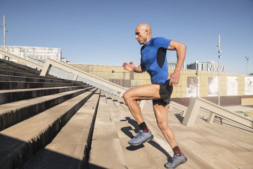 Sportsman running up stairs in a urban landscape