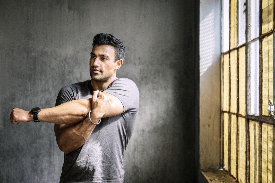 A man stretching at the gym