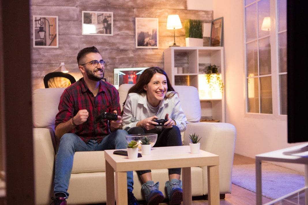 Happy young couple after winning at video games on television