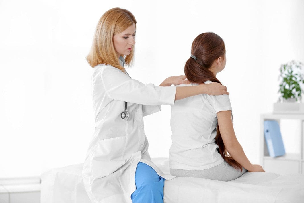 Incorrect posture concept. Physiotherapist examining and correct