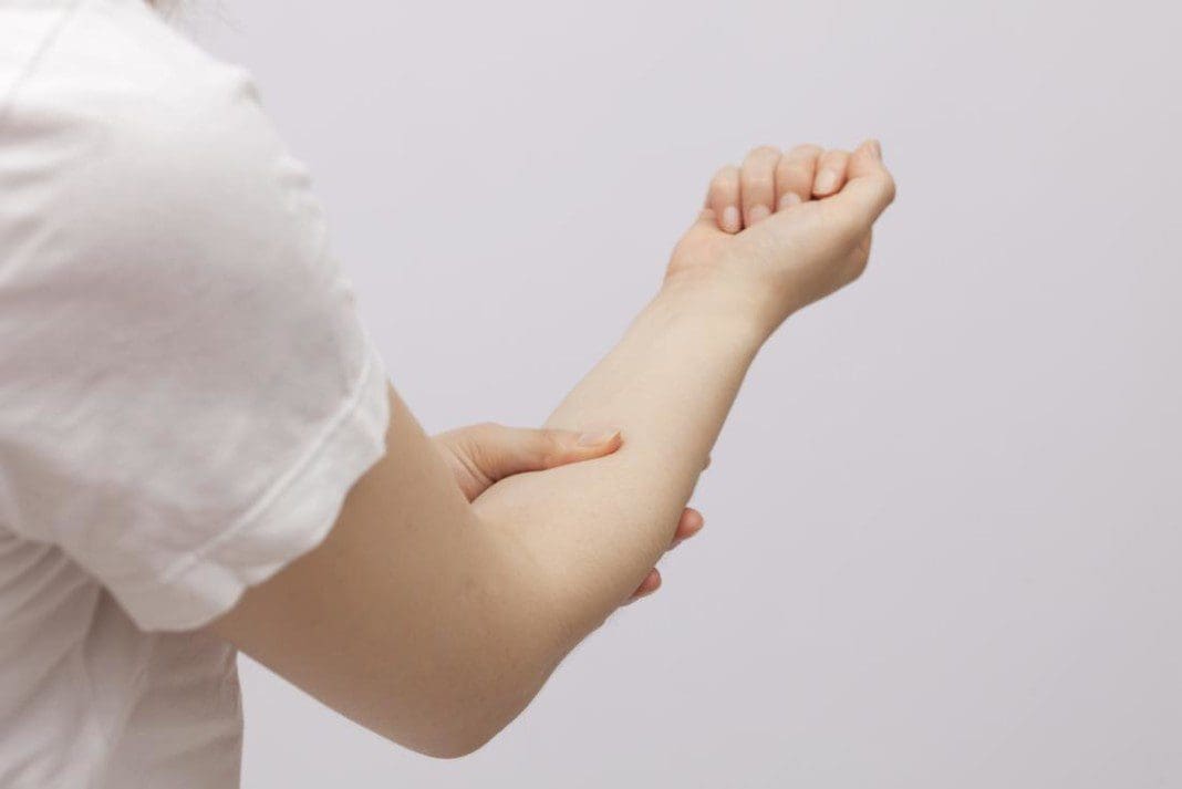 lady-holding-forearm-that-may-be-causing-her-pain