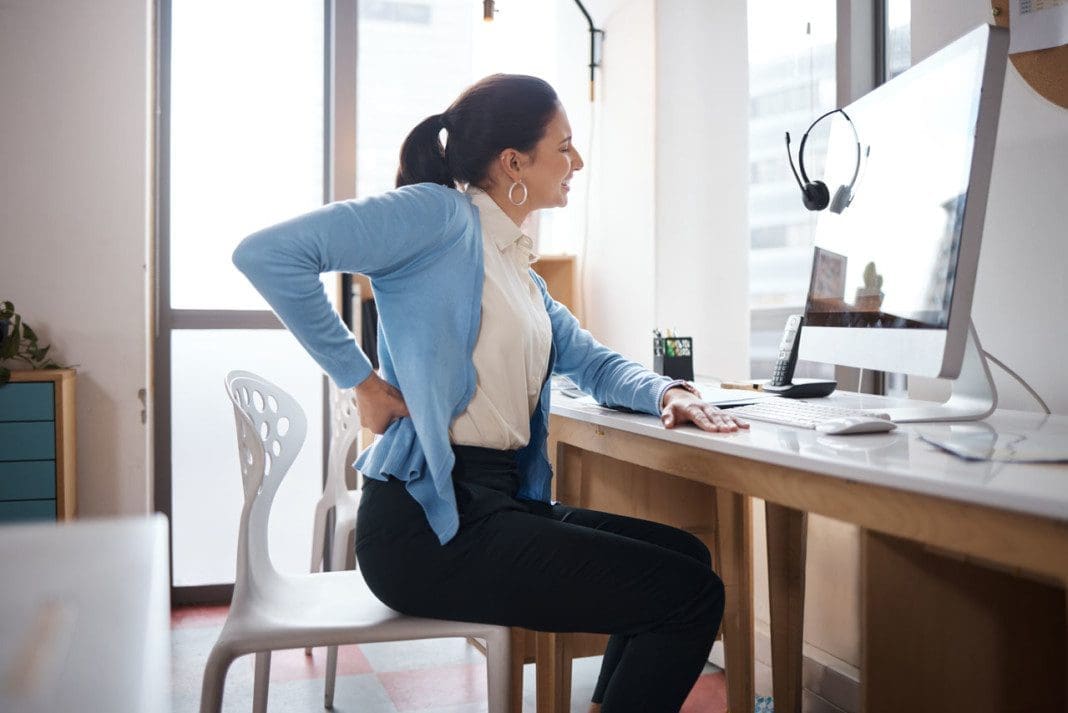 shot-of-a-young-businesswoman-experiencing-back-pa-2022-10-07-20-25-22-utc_02
