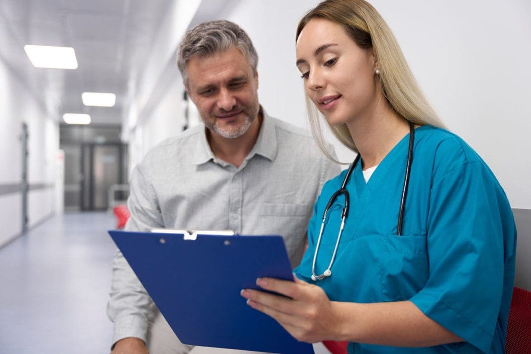 Smiling woman doctor showing documents to patient