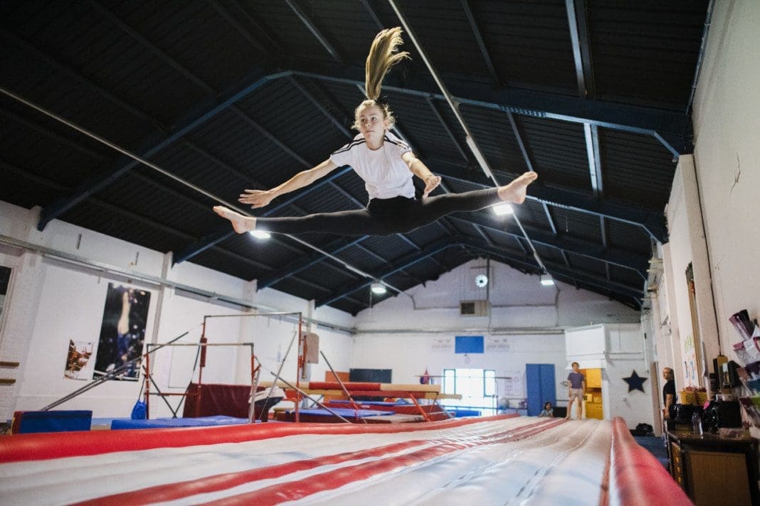 Female gymnast practicing a gymnastic