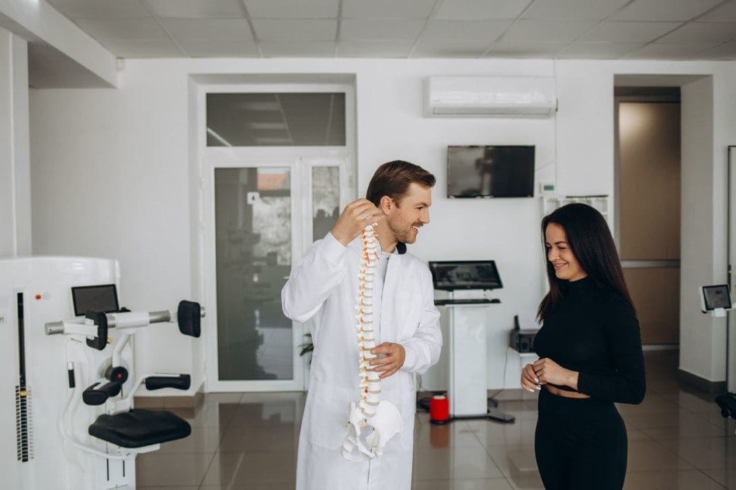 Young woman doing spine checkup at vertebra clinic