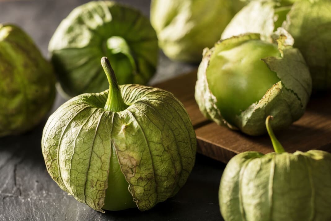 tomatillos in a pile in rustic scene