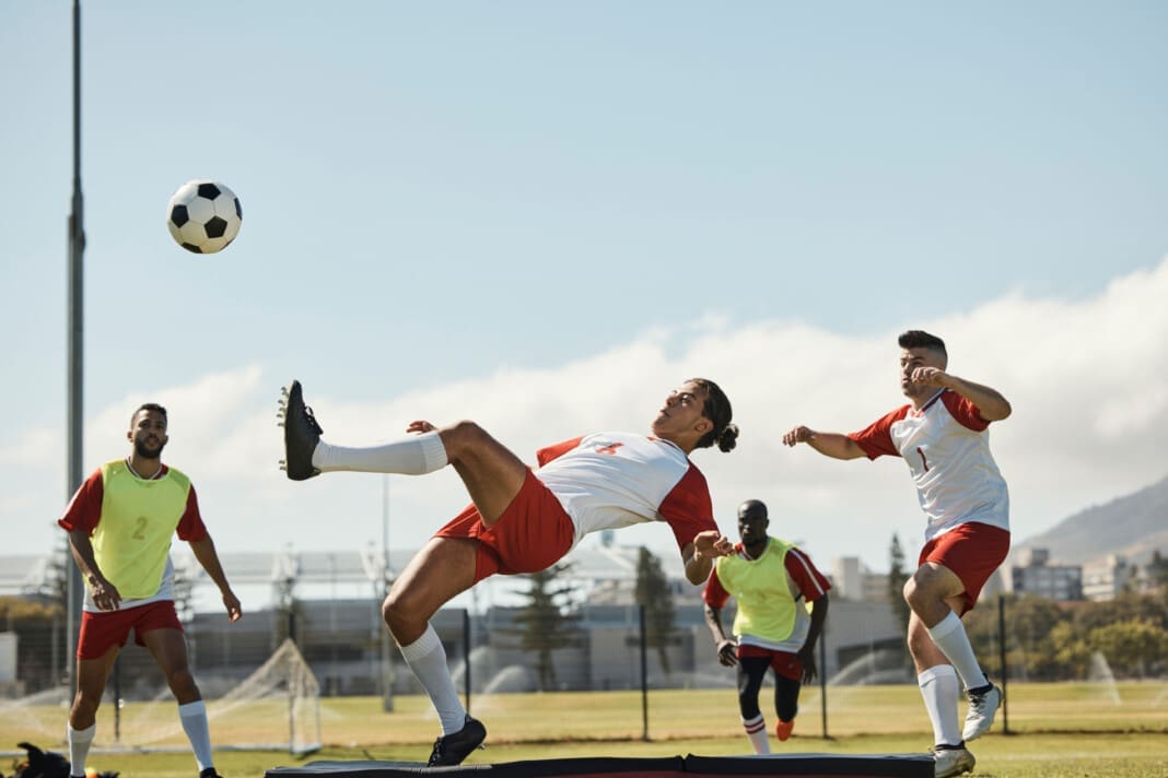 Sports, soccer and soccer player with team and soccer ball in po