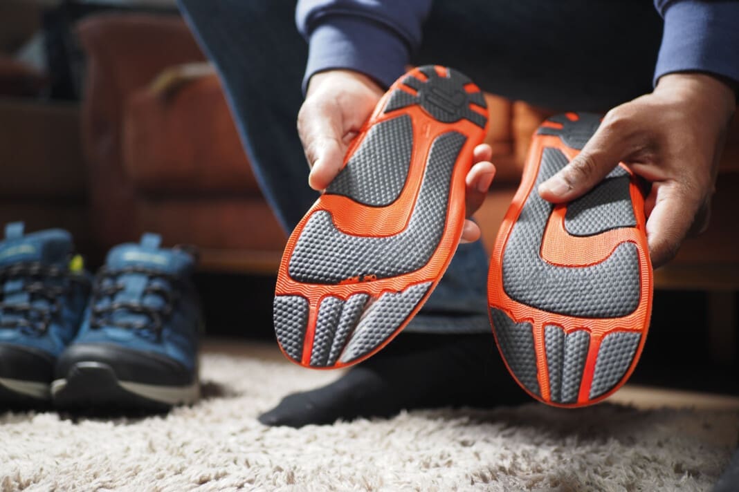 men hand putting Orthopedic insoles in shoes