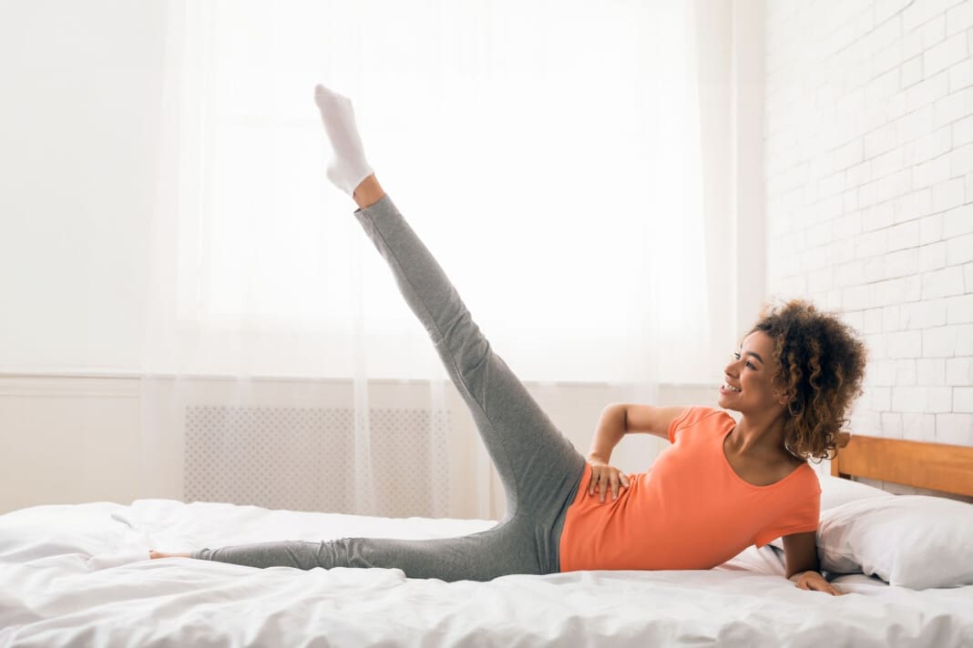Girl exercising in bed in the morning