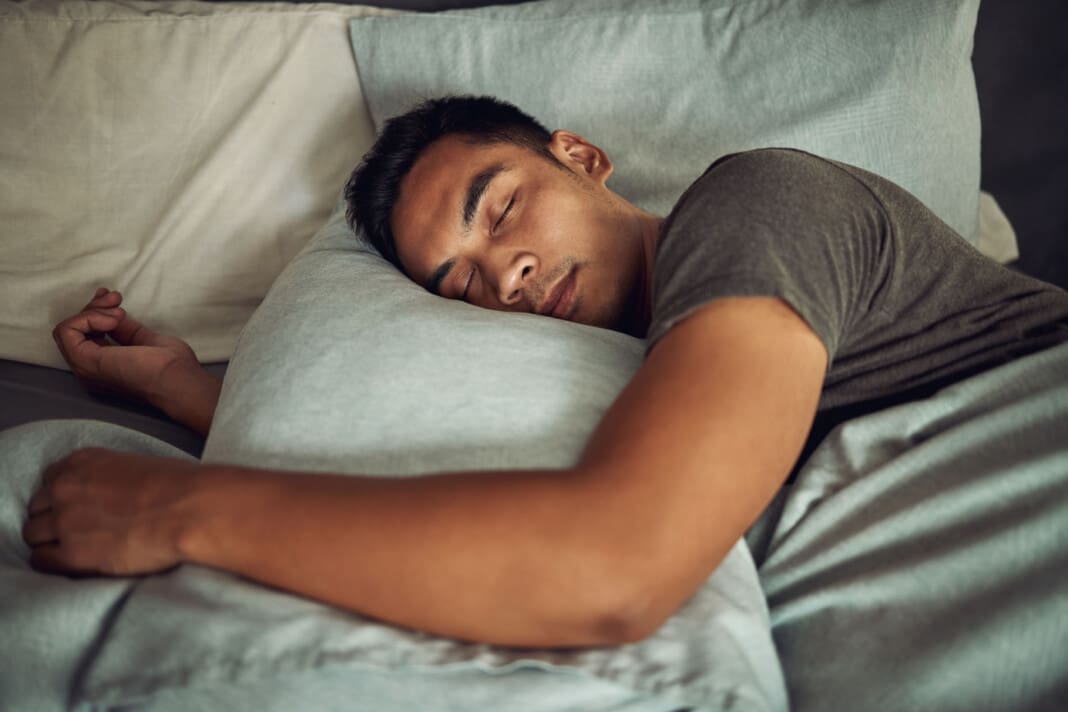 Nothing soothes the soul like a deep sleep. Shot of a young man